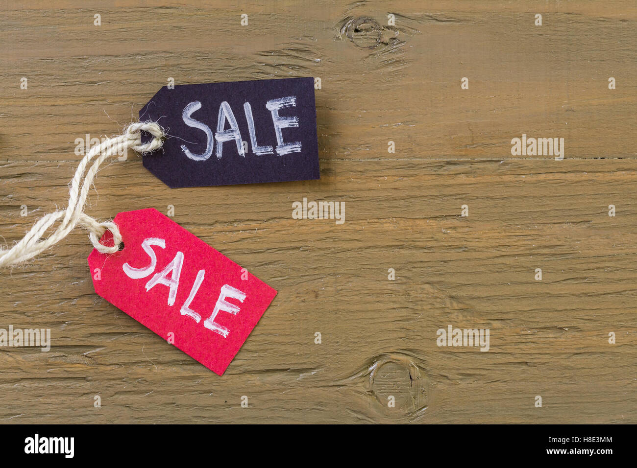 Tags with sale sign on wood board Stock Photo Alamy