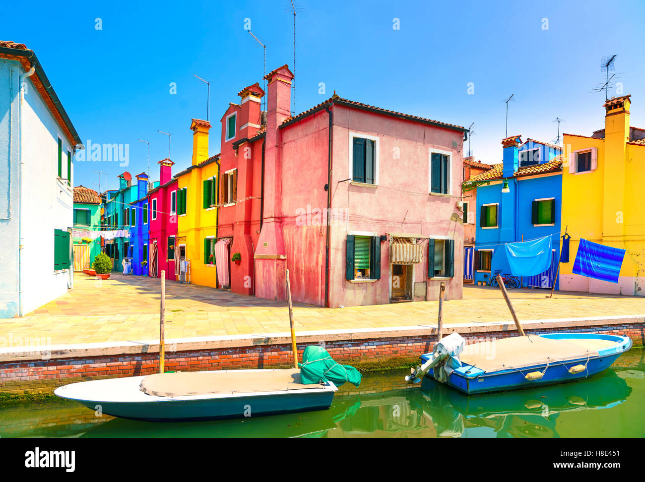 Venice landmark, Burano island canal, colorful houses and boats, Italy. Long exposure photography Stock Photo