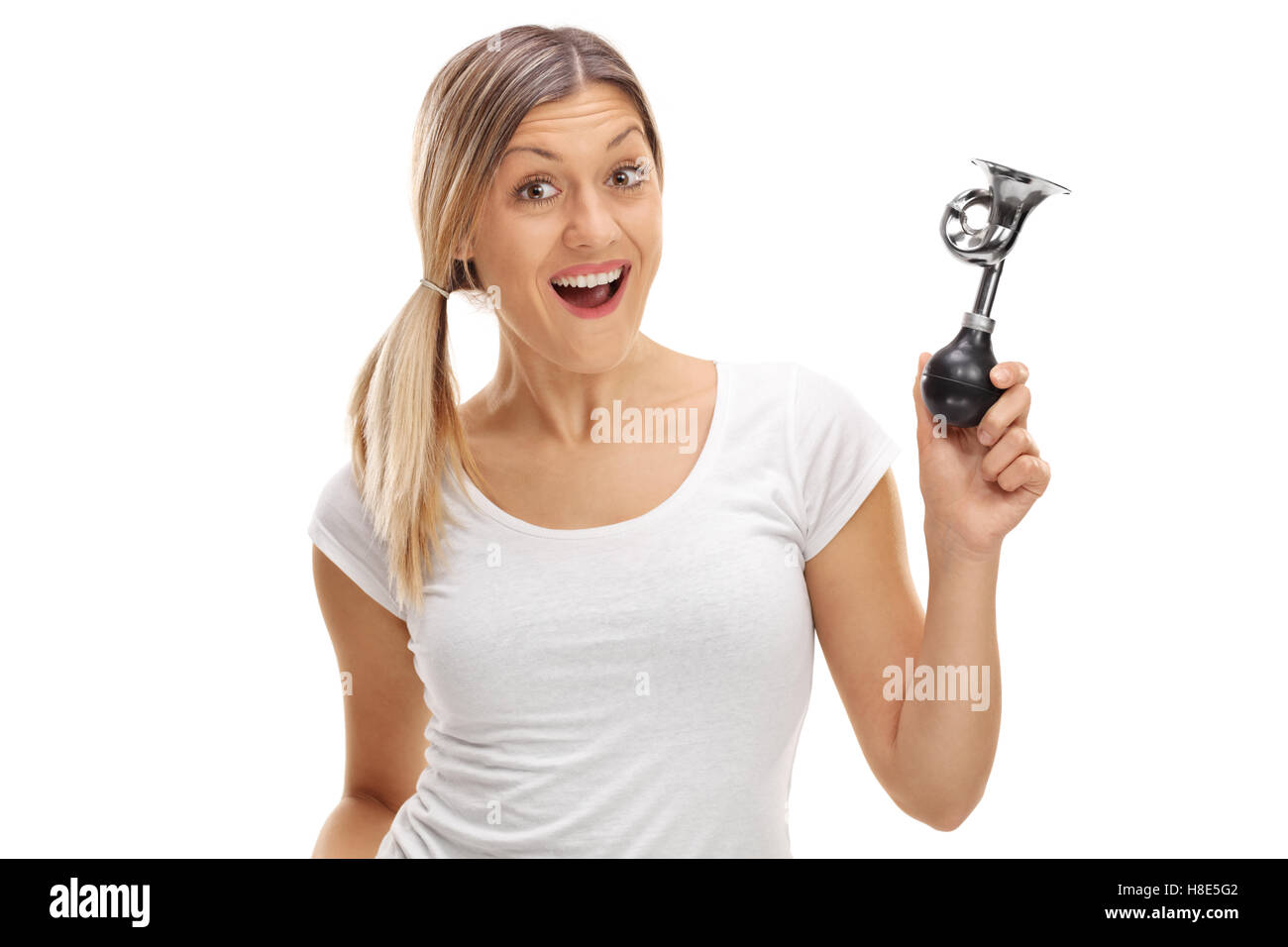 Delighted woman holding a horn isolated on white background Stock Photo