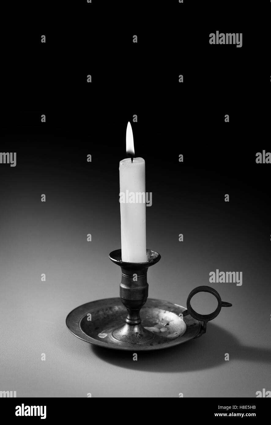 Single candle burning Stock Photo