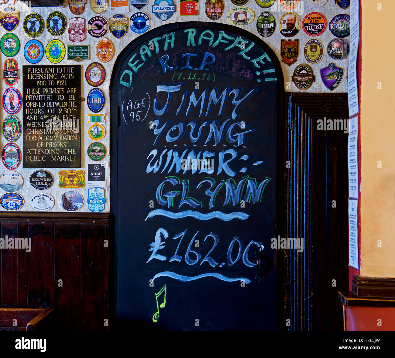 Interior of pub, with blackboard: Death Raffle, with locals betting on which celebrity dies next, England UK Stock Photo