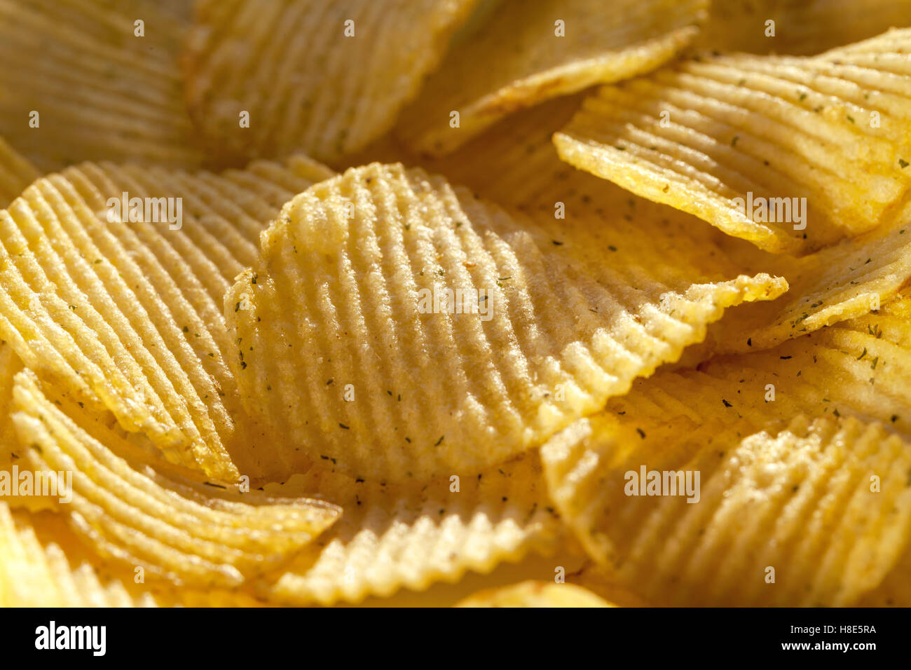 Background of delicious potato chips with spices. Closeup Stock Photo