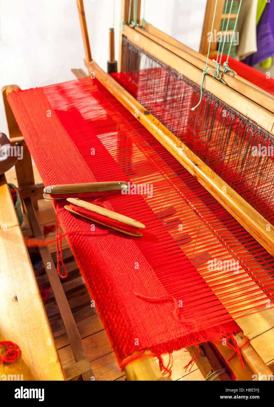 Vintage wooden loom weaving prepared for the red carpet. Wooden weaving