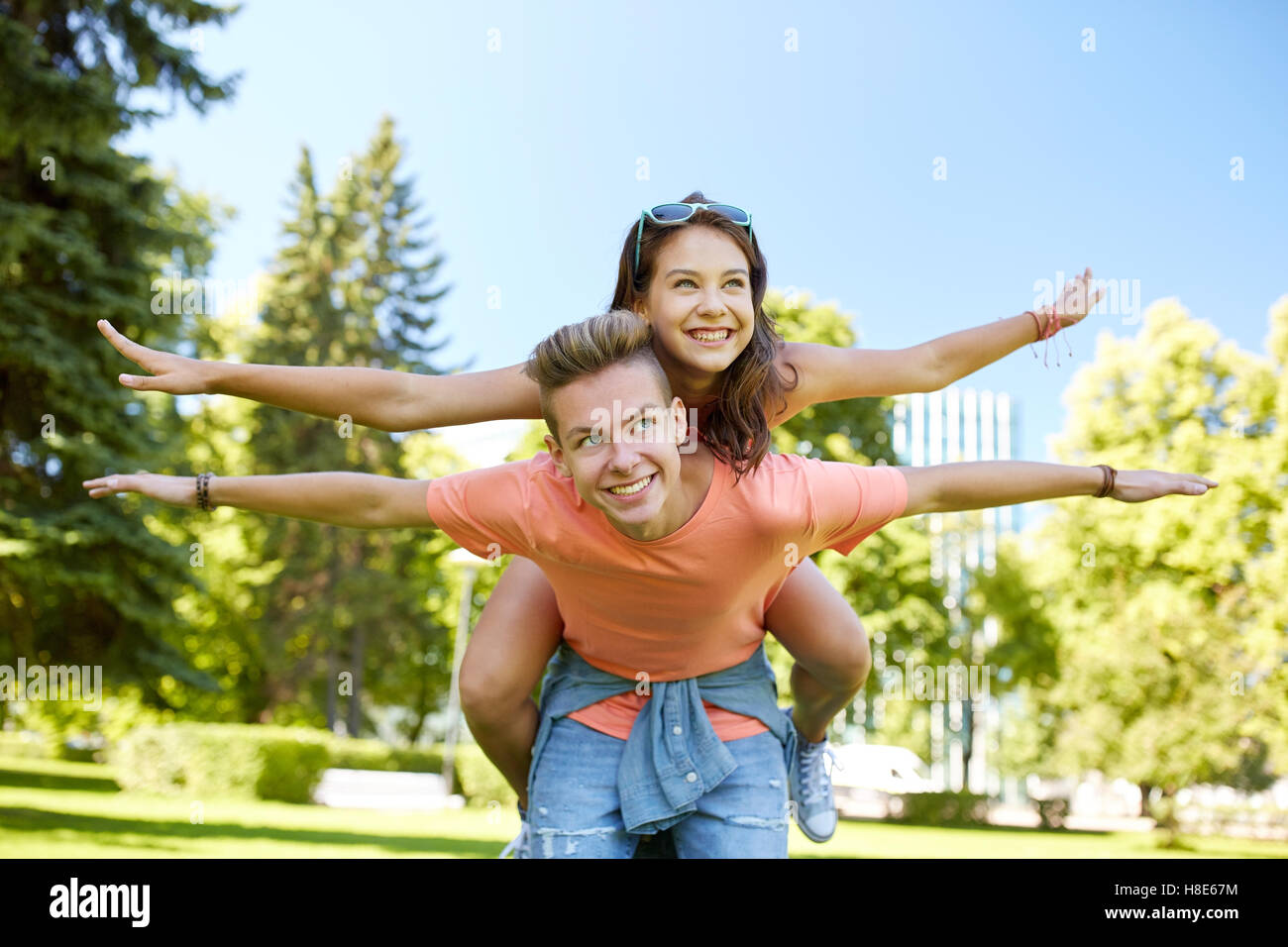 happy teenage couple having fun at summer park Stock Photo - Alamy