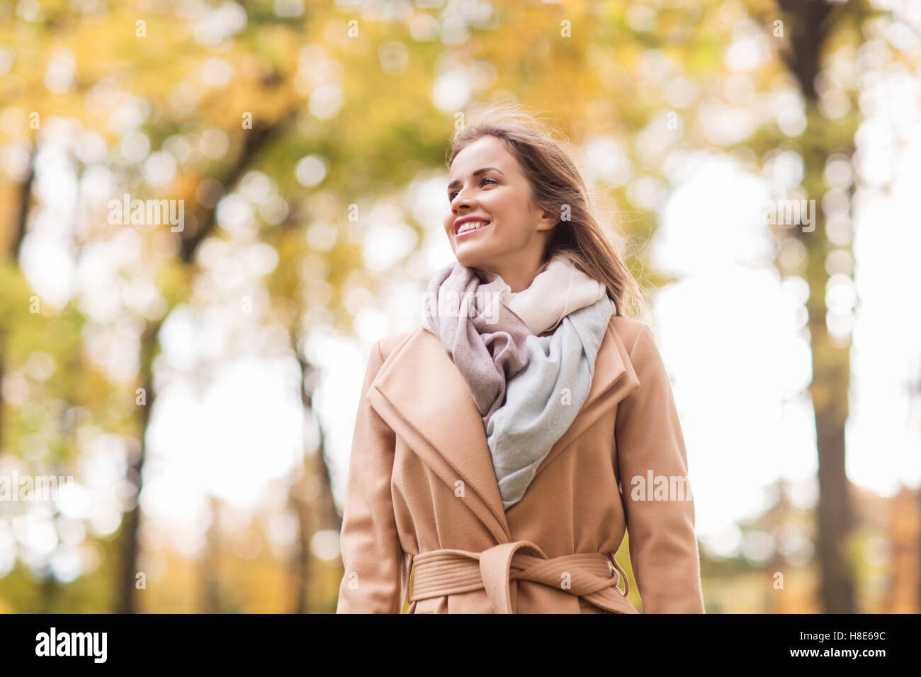 beautiful happy young woman walking in autumn park Stock Photo - Alamy