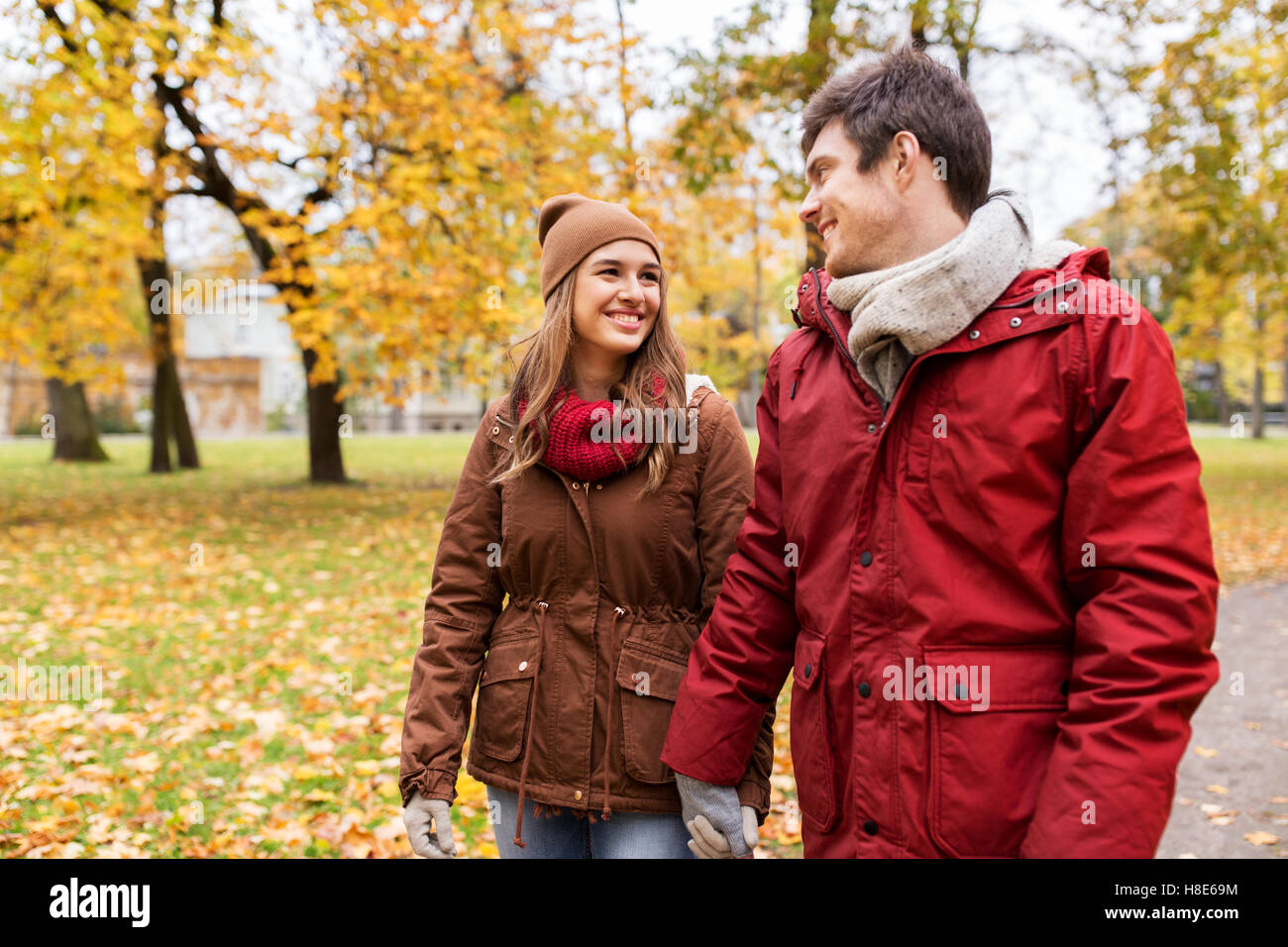 happy young couple walking in autumn park Stock Photo - Alamy