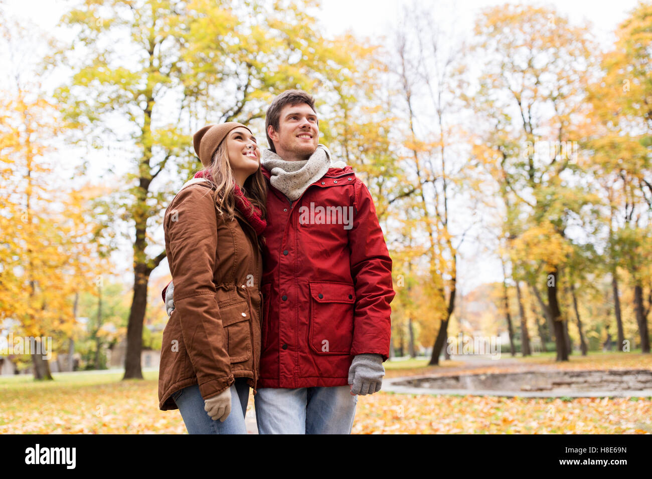 happy young couple walking in autumn park Stock Photo - Alamy