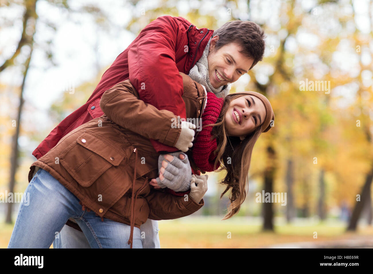happy young couple having fun in autumn park Stock Photo - Alamy