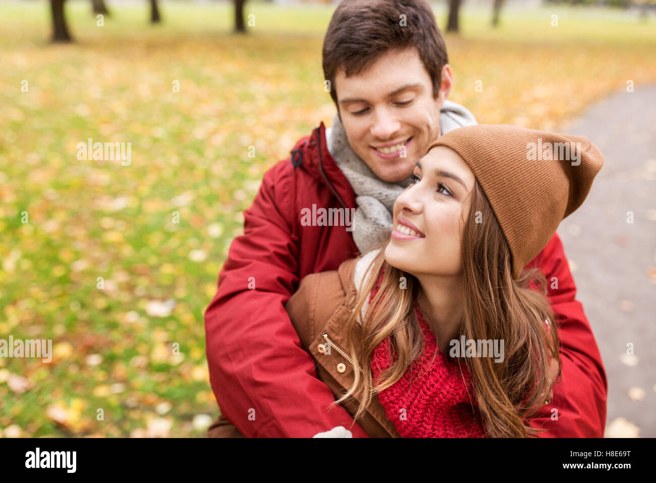 happy young couple hugging in autumn park Stock Photo - Alamy