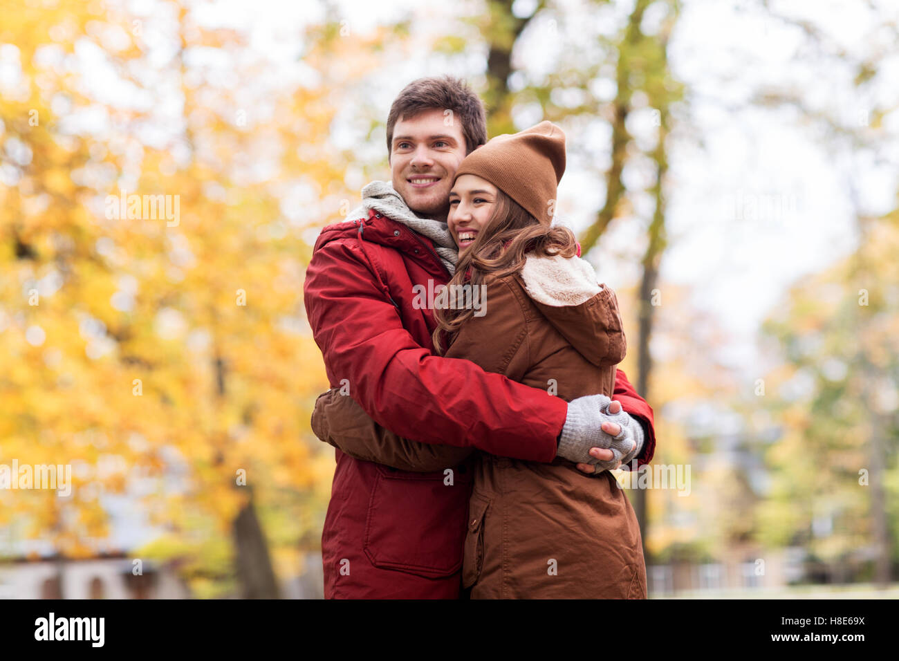 happy young couple hugging in autumn park Stock Photo - Alamy