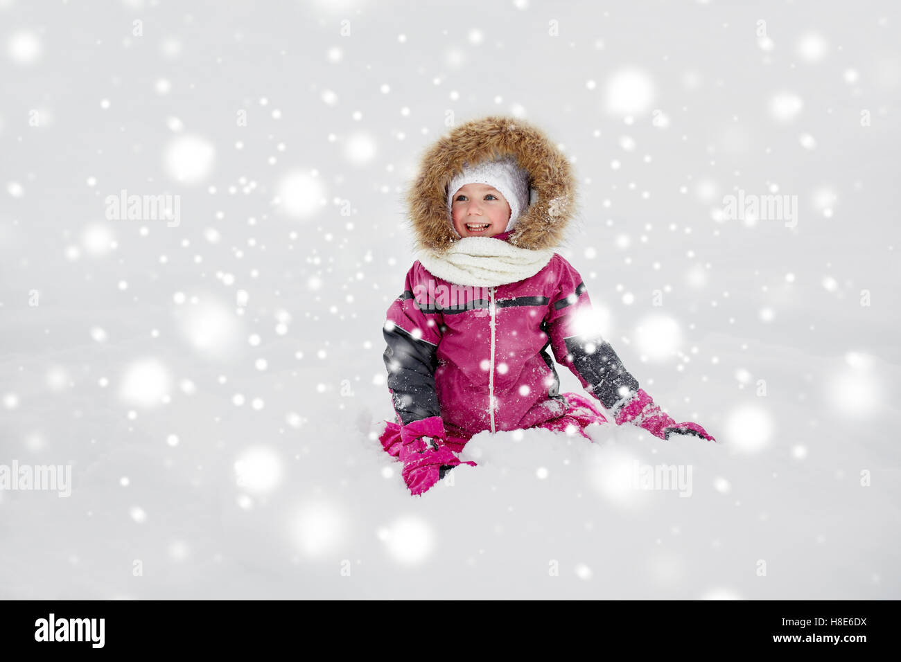 happy little kid or girl in winter clothes on snow Stock Photo - Alamy