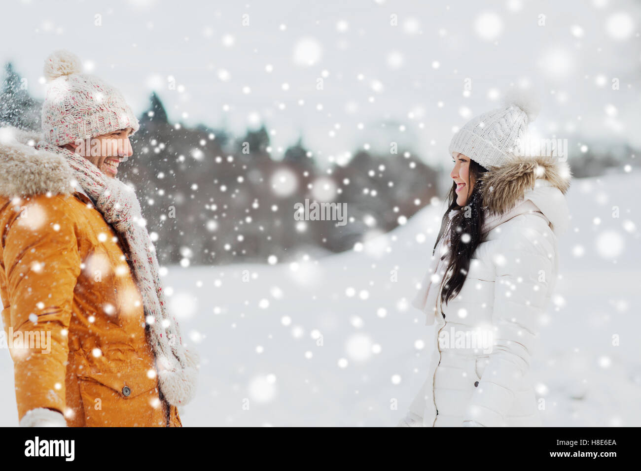 happy couple walking over winter background Stock Photo - Alamy