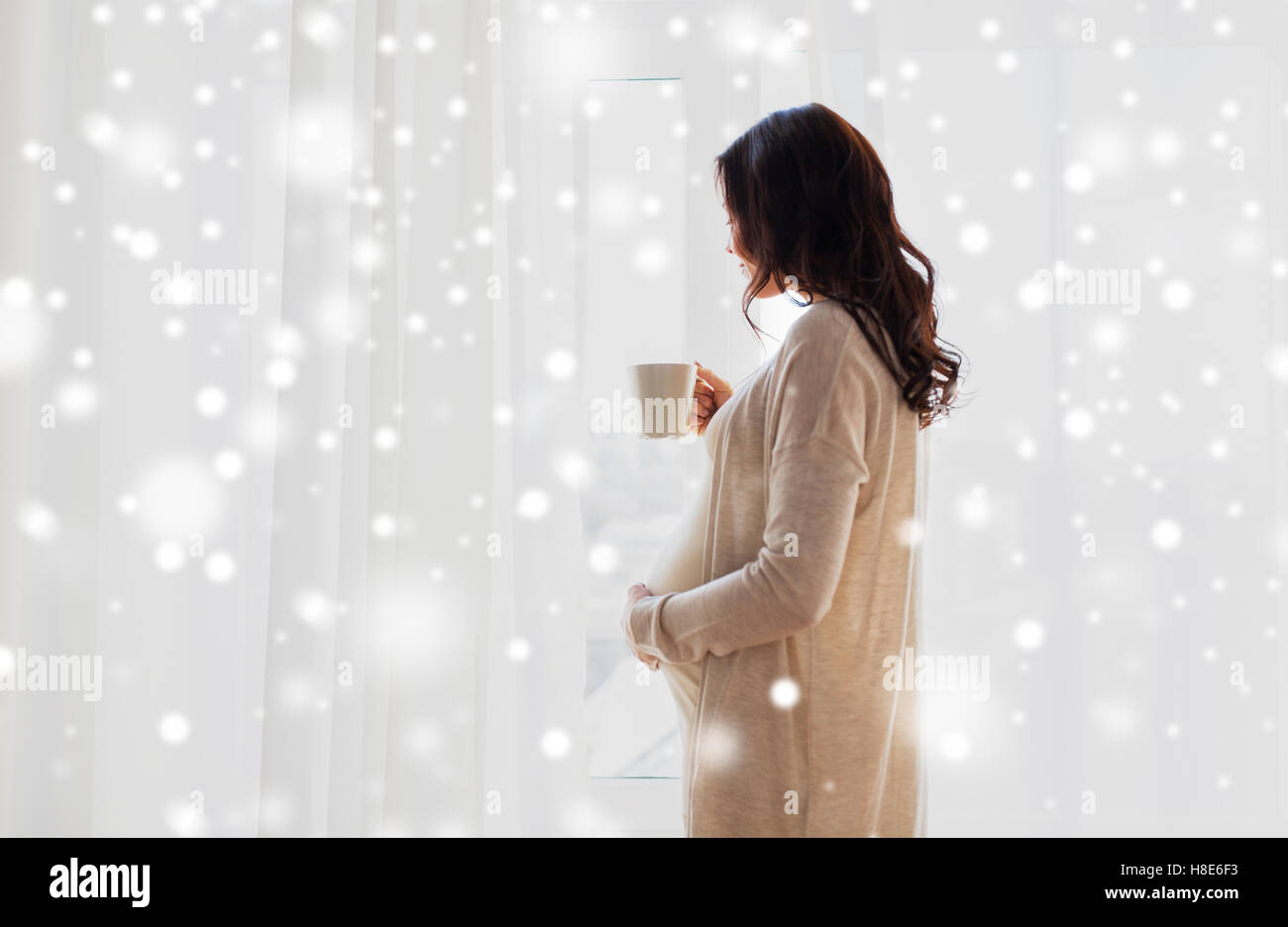 close up of pregnant woman with tea cup at window Stock Photo - Alamy