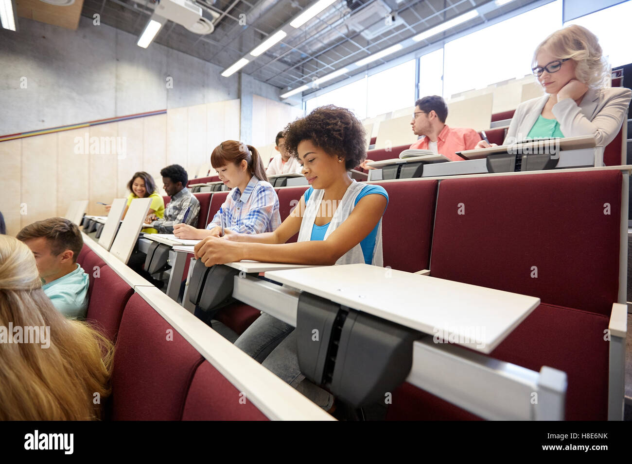 group of students with notebooks at lecture hall Stock Photo Alamy
