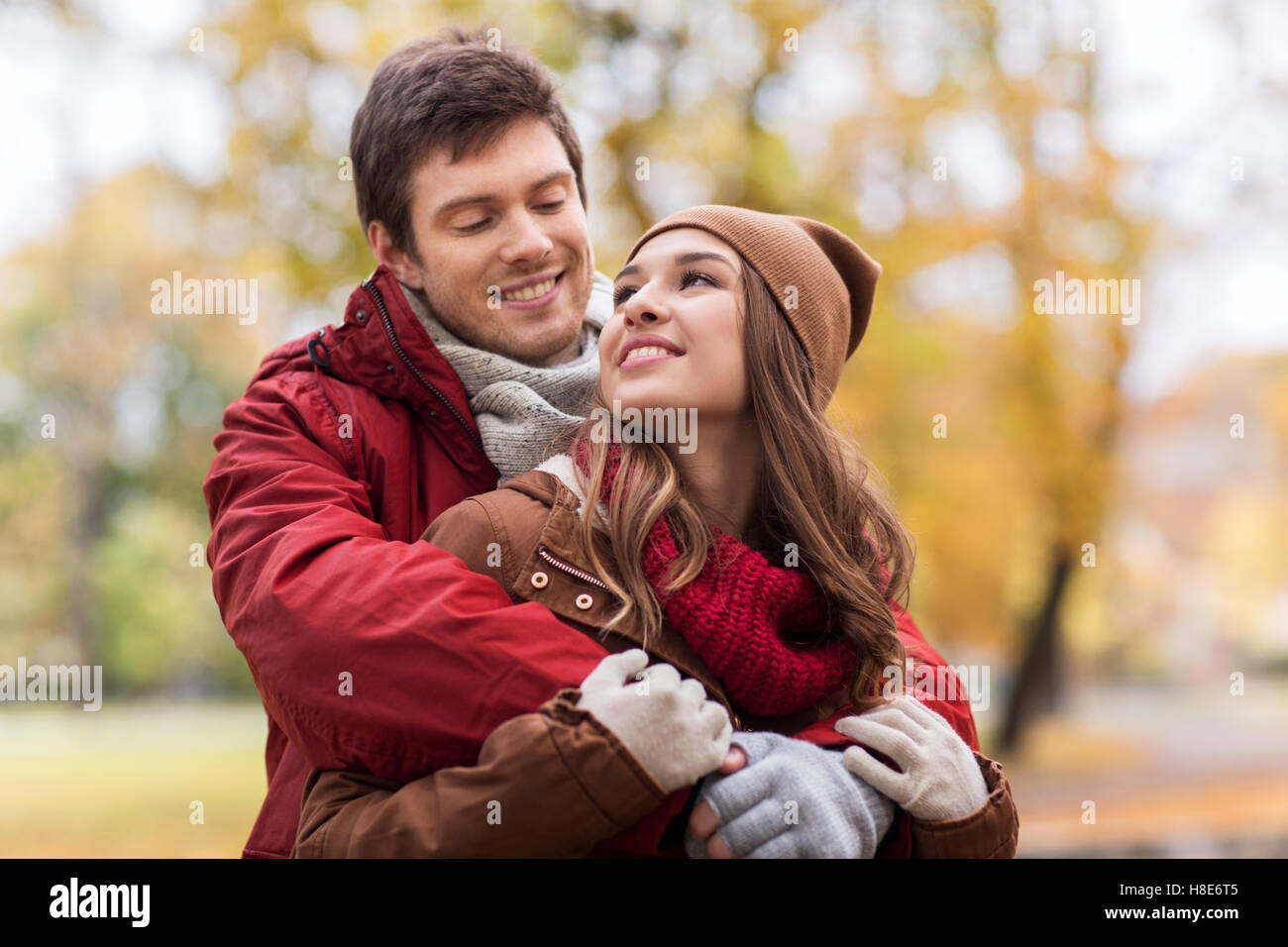 happy young couple hugging in autumn park Stock Photo - Alamy