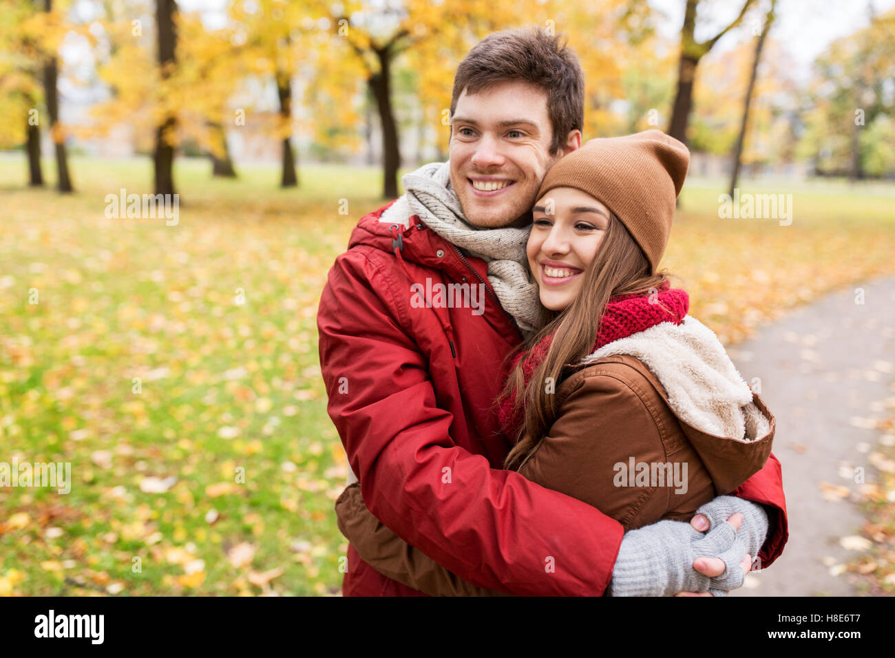 happy young couple hugging in autumn park Stock Photo - Alamy