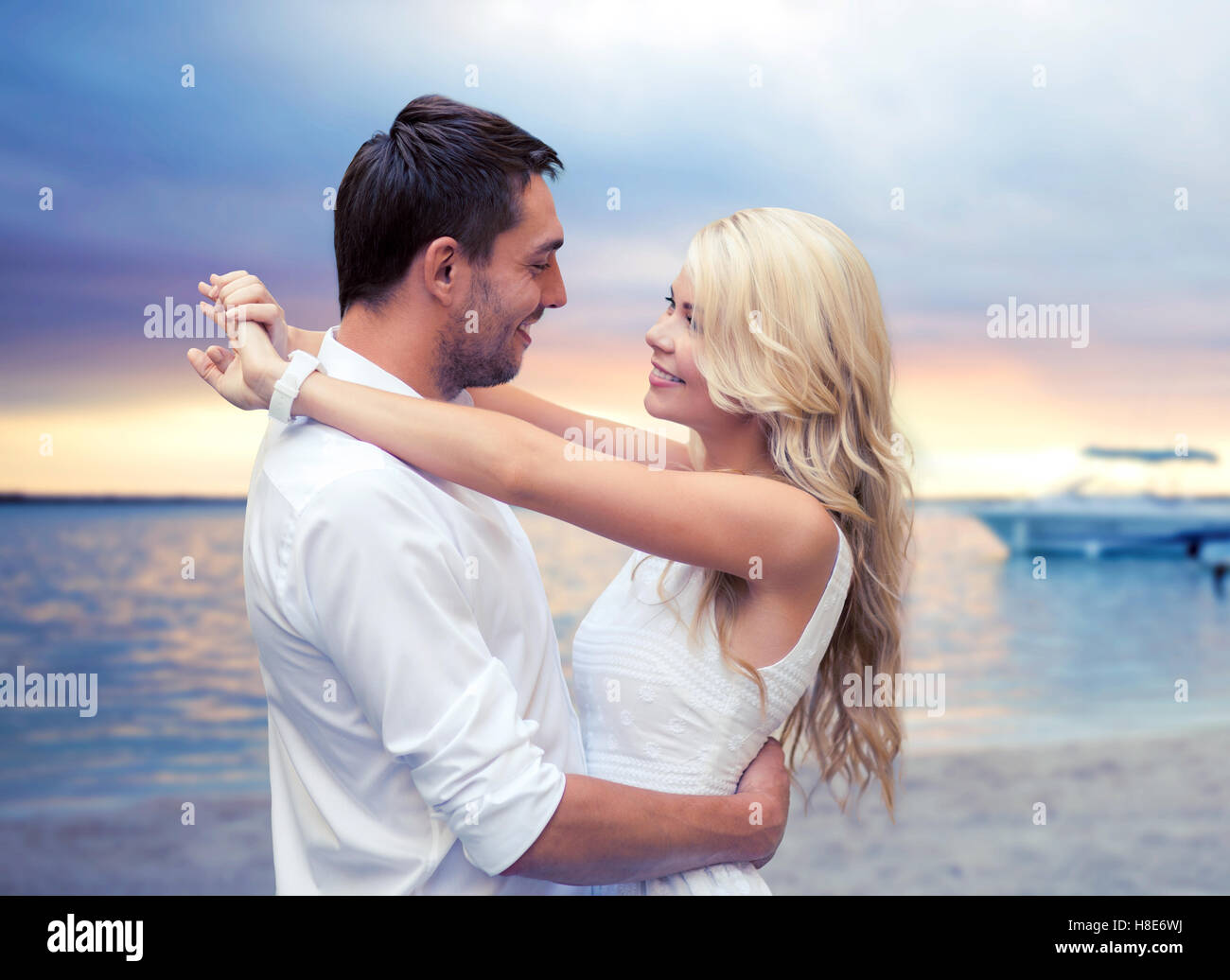 happy couple hugging over sunset beach background Stock Photo - Alamy