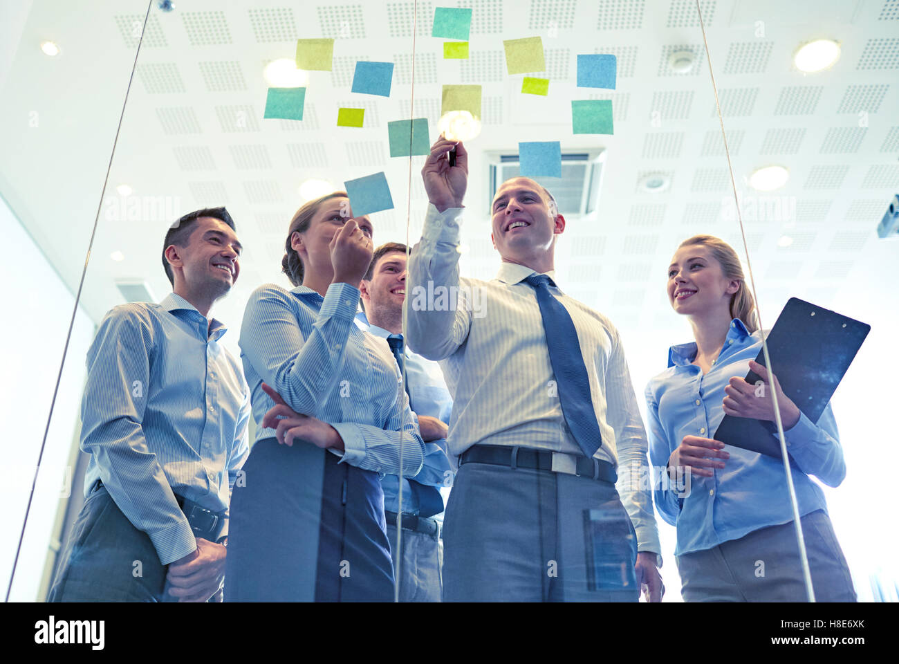 smiling business people with marker and stickers Stock Photo - Alamy