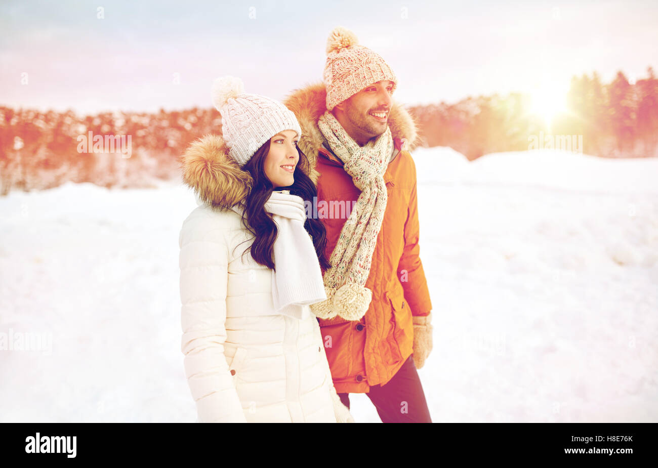 happy couple walking over winter background Stock Photo - Alamy