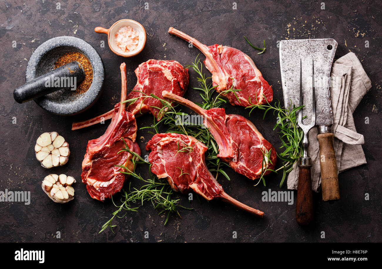 Raw fresh meat Veal ribs, spices and Vintage kitchen utensils on dark background Stock Photo