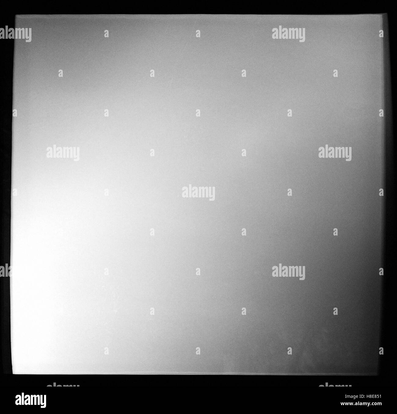 Empty square black and white film frame with heavy grain and light leak Stock Photo