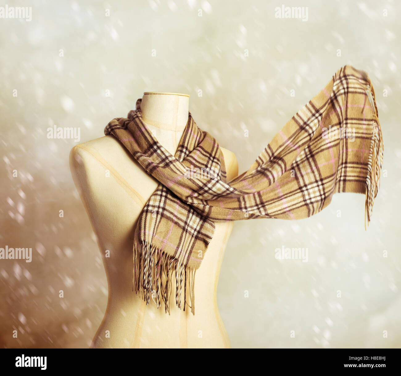 Vintage tailors dummy with woollen winter scarf - blur in scarf to give motion effect Stock Photo