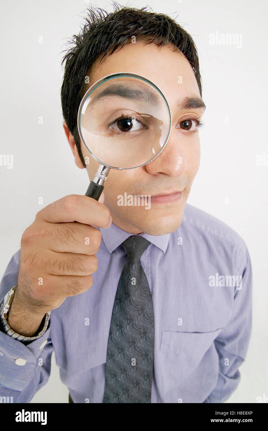 Businessman holding magnifying glass Stock Photo Alamy