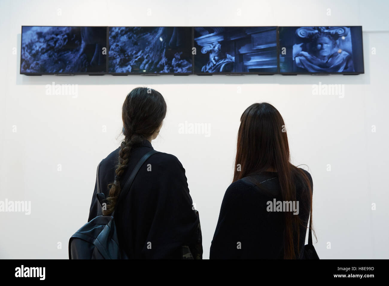 Women looking at video art during Artissima, contemporary art fair opening on in Turin Stock Photo