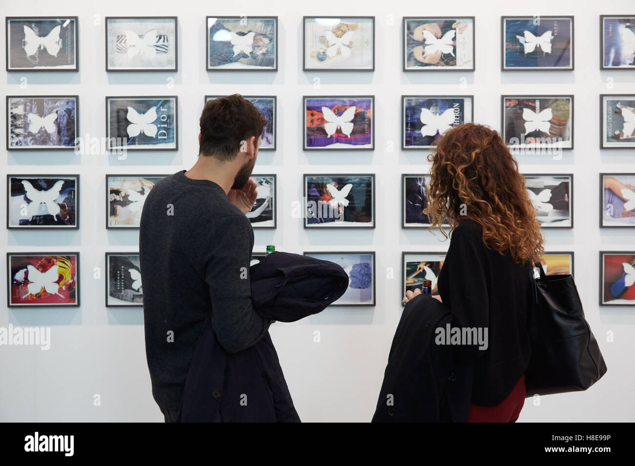 Young man and woman looking at artworks during Artissima, contemporary art fair opening with people Stock Photo