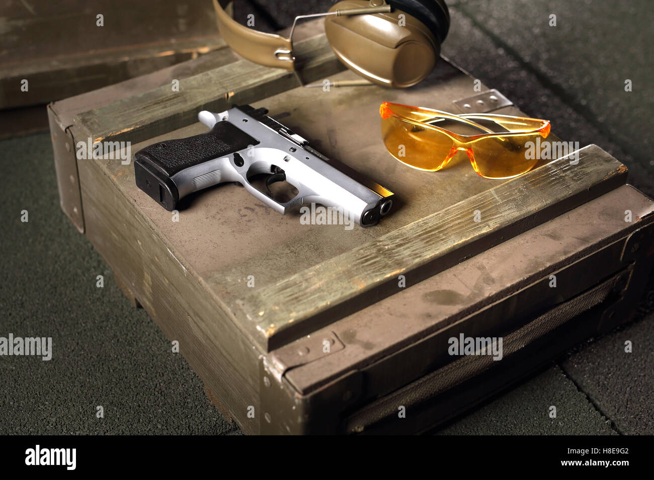 Handgun, pistol. Equipment shooting gun. Gun, cartridges and headphones