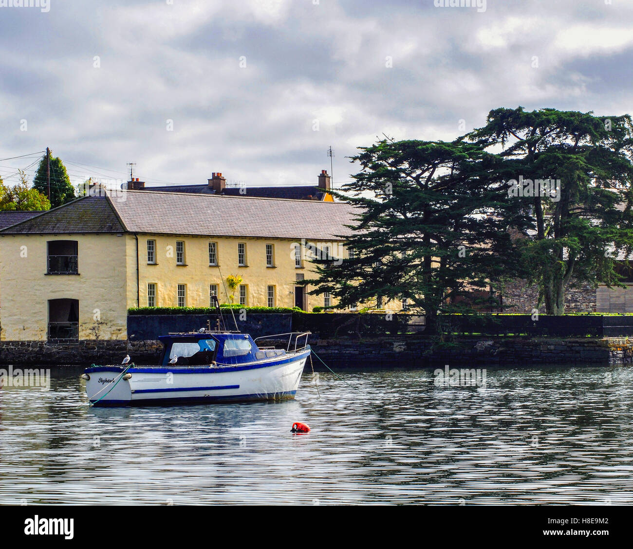Small motor boat moored in the harbour town of Kinsale, County Cork, Ireland with copy space. Stock Photo