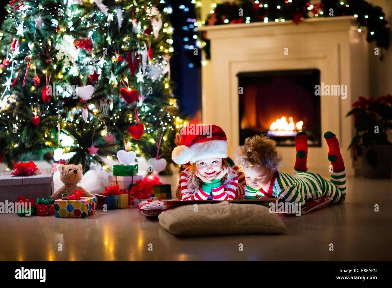 Beautiful woman in striped pyjamas on a Christmas Day Stock Photo - Alamy