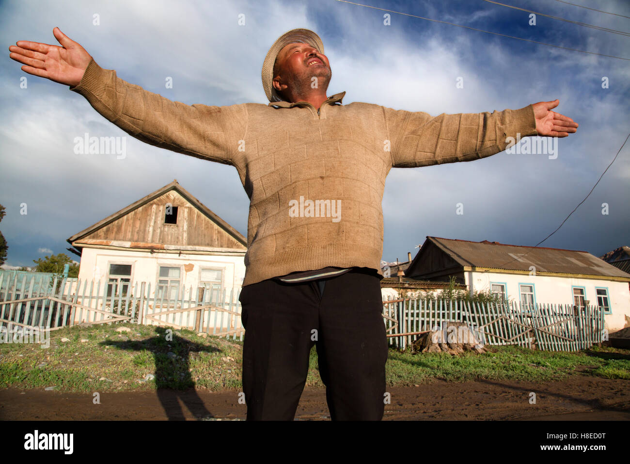 Kyrgyzstan - portrait of man in Tamga village in front of his house -  Travel people Central Asia - Silk Road Stock Photo