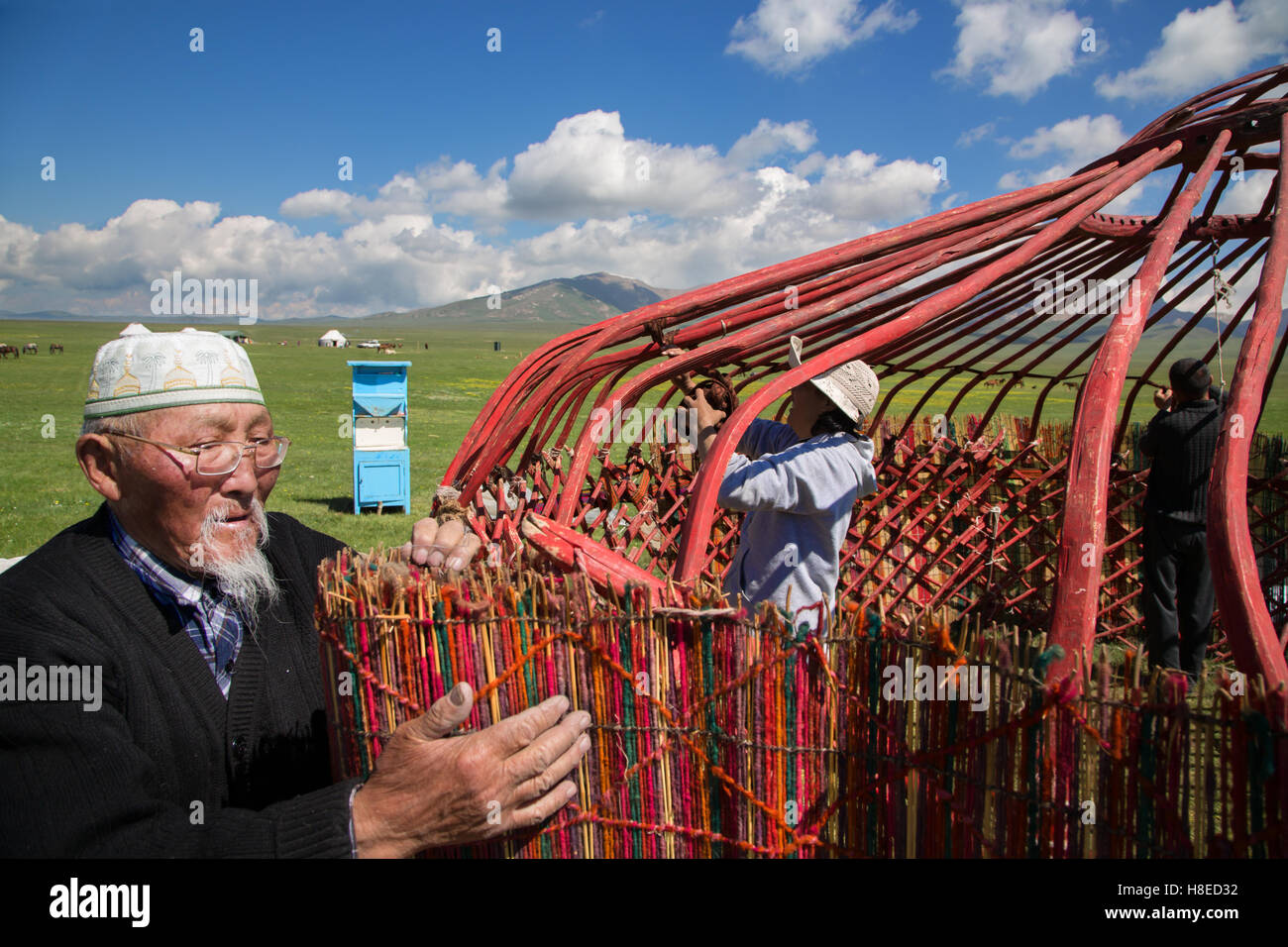 Kyrgyzstan - A nomadic family building a traditional yurt near lake Song Kol Stock Photo