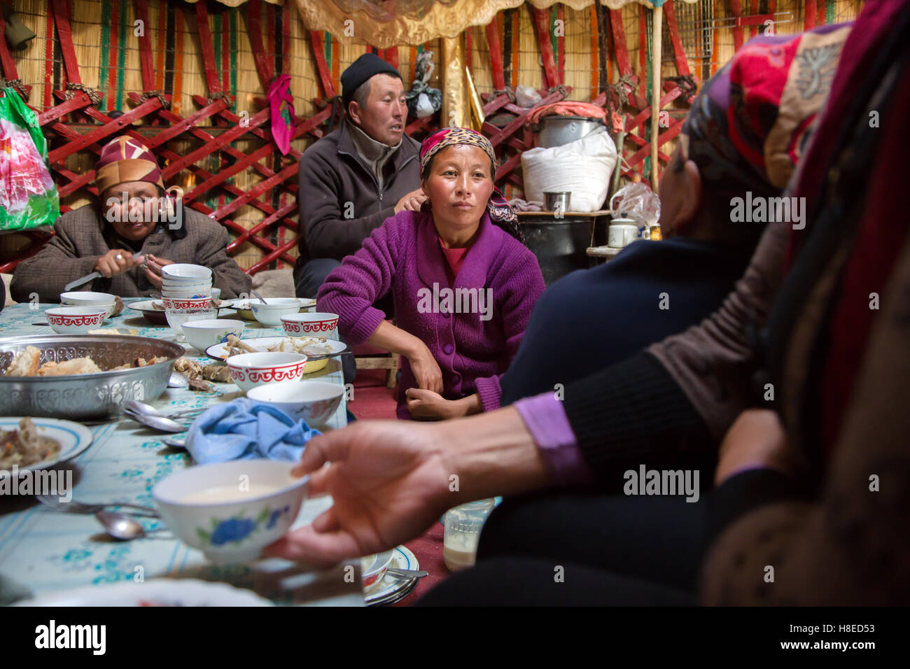 Kyrgyzstan - eating inside a traditional nomads yurt at lake Song Kol  -  Travel people Central Asia Stock Photo
