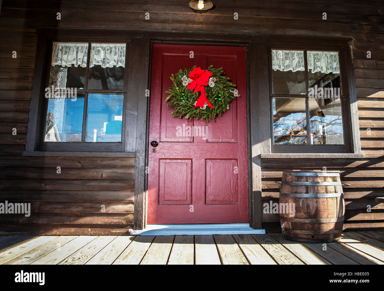 Christmas Wreath Decoration On A Red Colour Cabin House Front