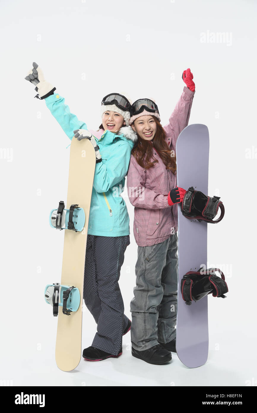 Young Japanese women wearing snowboard wear on white background Stock