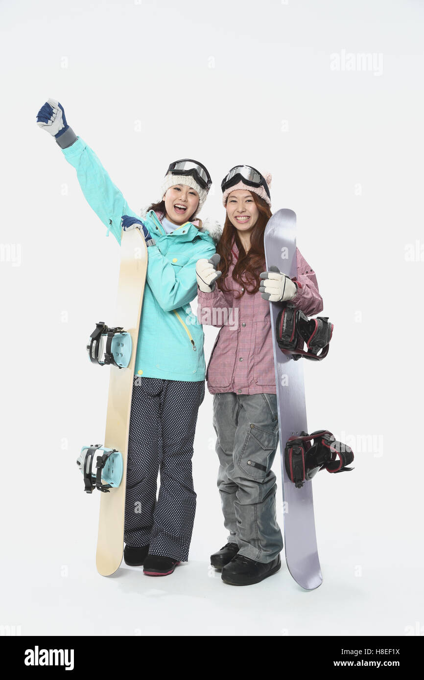 Young Japanese women wearing snowboard wear on white background Stock