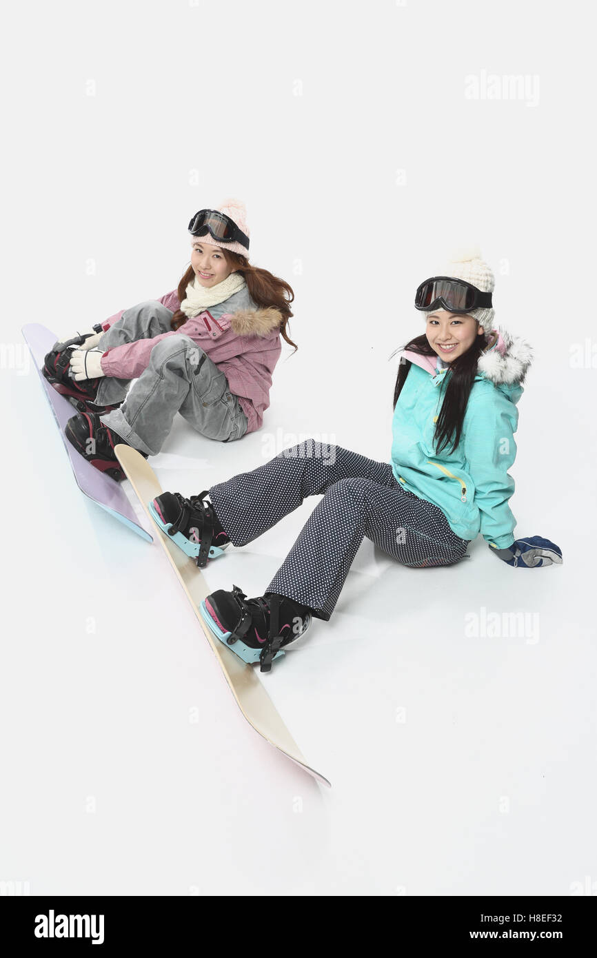 Young Japanese women wearing snowboard wear on white background Stock