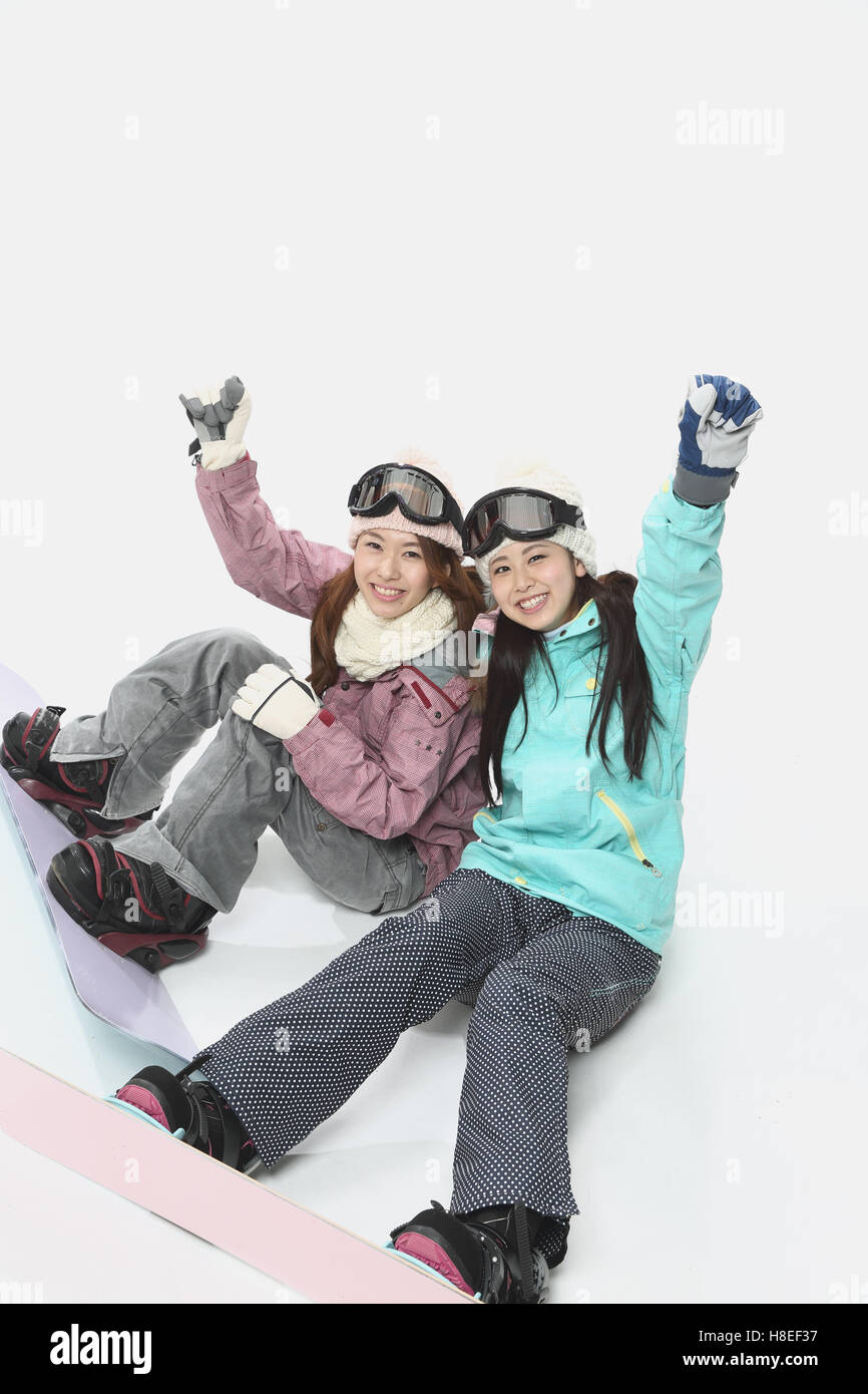 Young Japanese women wearing snowboard wear on white background Stock