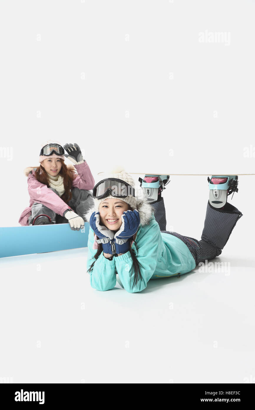 Young Japanese women wearing snowboard wear on white background Stock