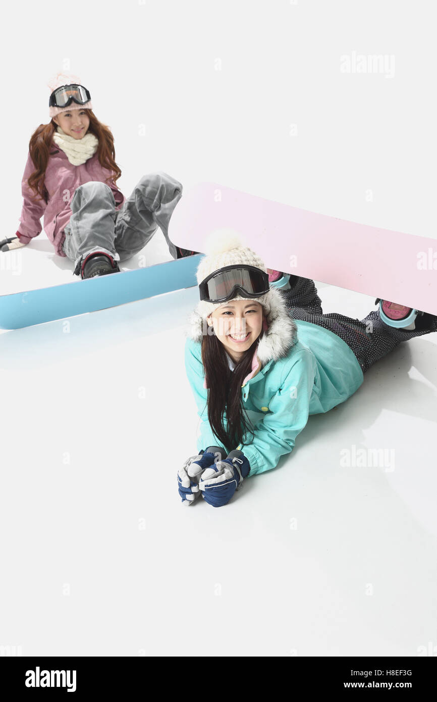 Young Japanese women wearing snowboard wear on white background Stock
