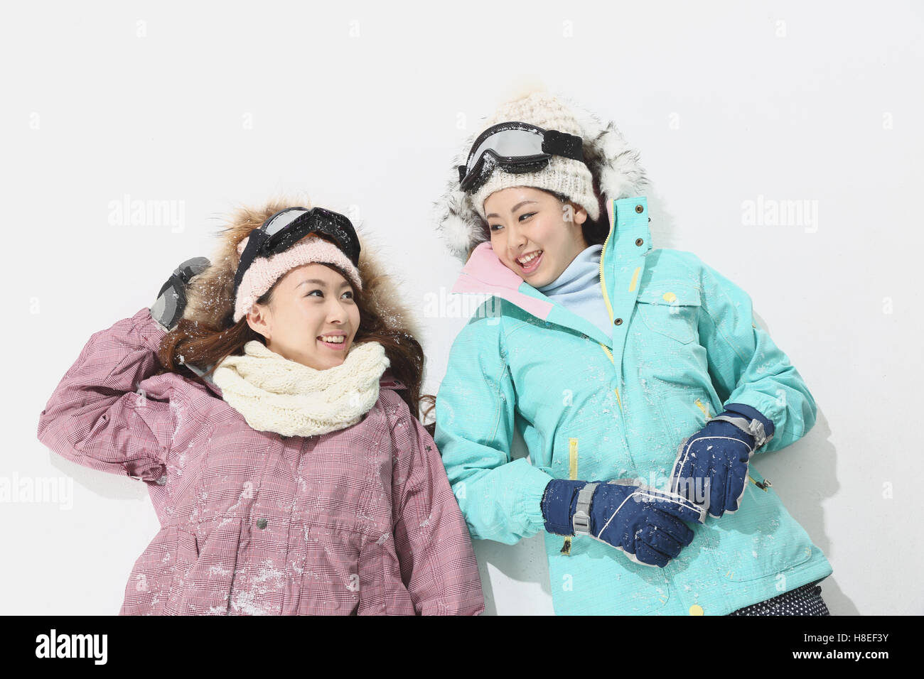 Young Japanese women wearing snowboard wear on white background Stock