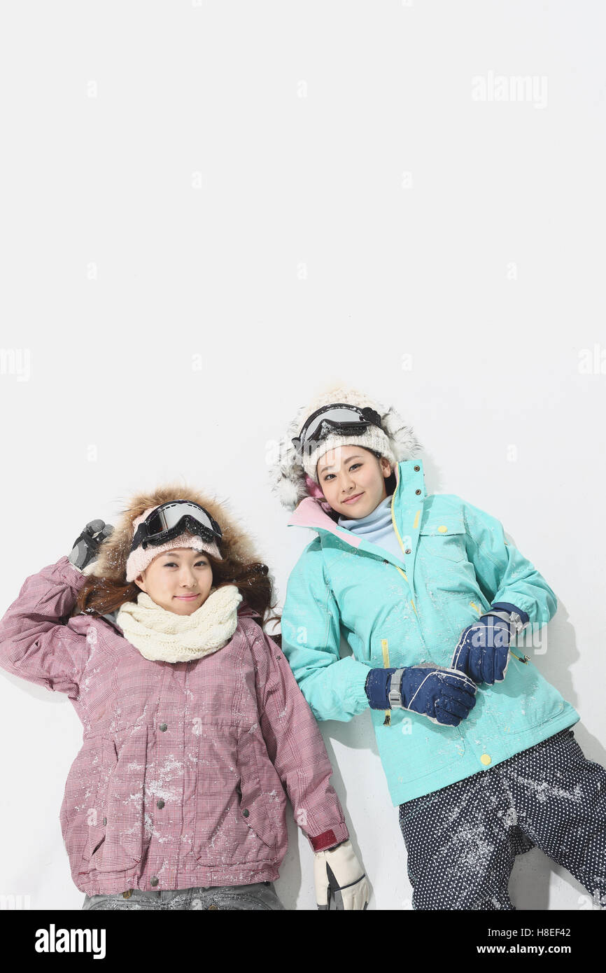 Young Japanese women wearing snowboard wear on white background Stock