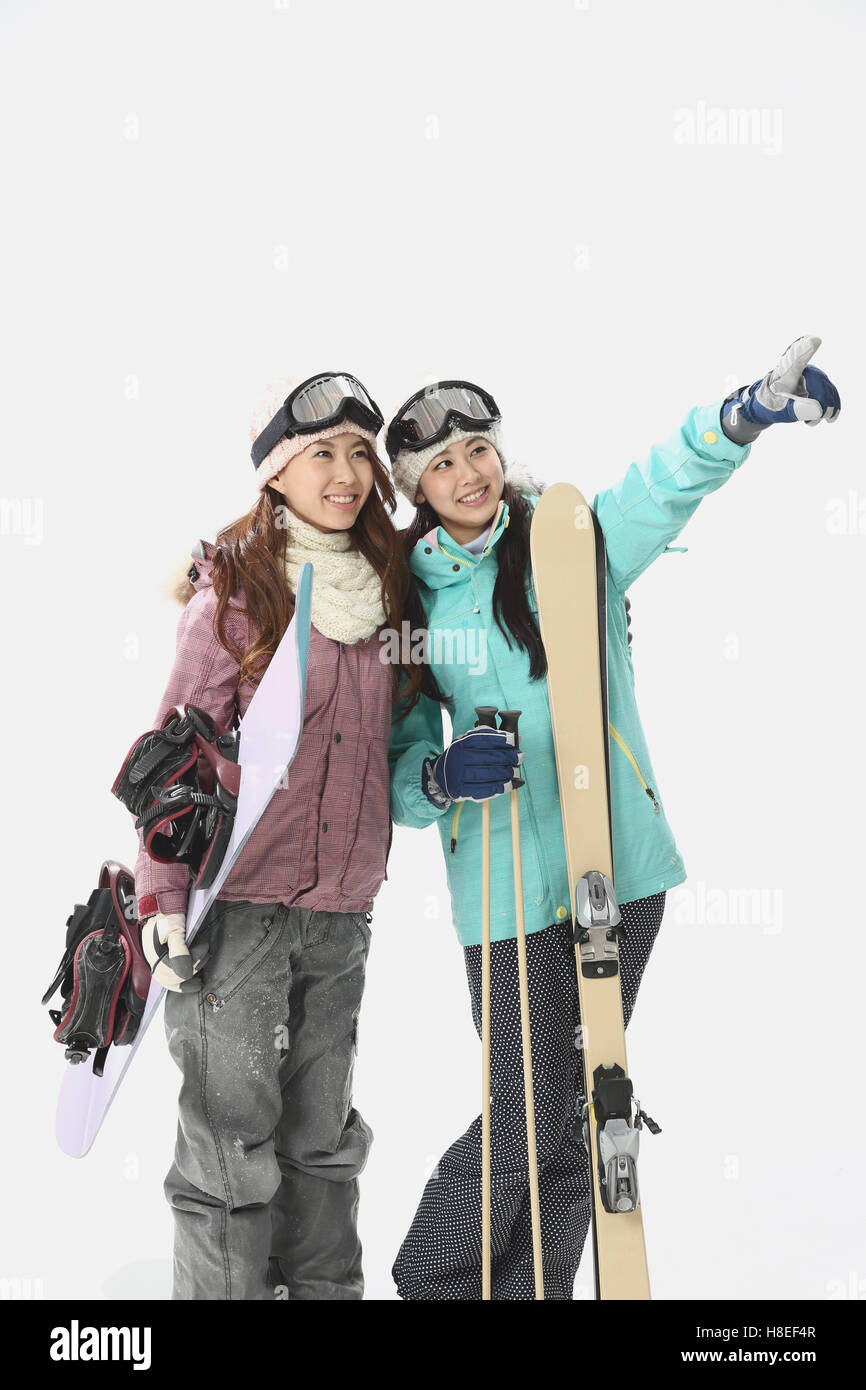 Young Japanese women wearing snowboard wear on white background Stock