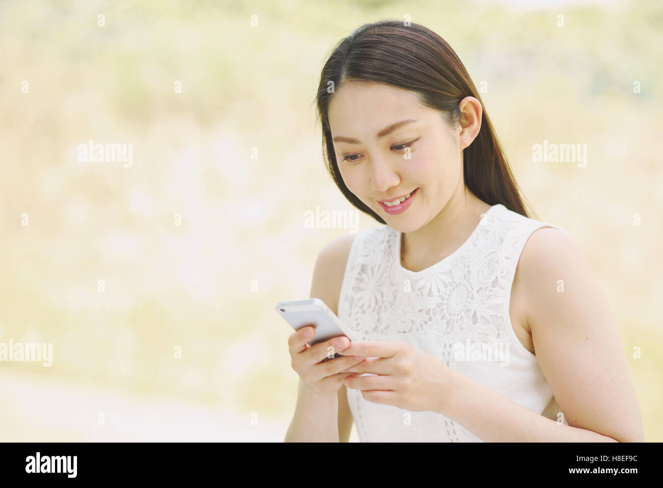 Portrait of young Japanese woman with smartphone Stock Photo