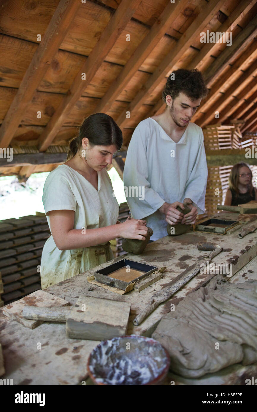 Workers at Guedelon making roof tiles by hand destined for the cheatu. All work carried at out the chateau is done in the tradit Stock Photo
