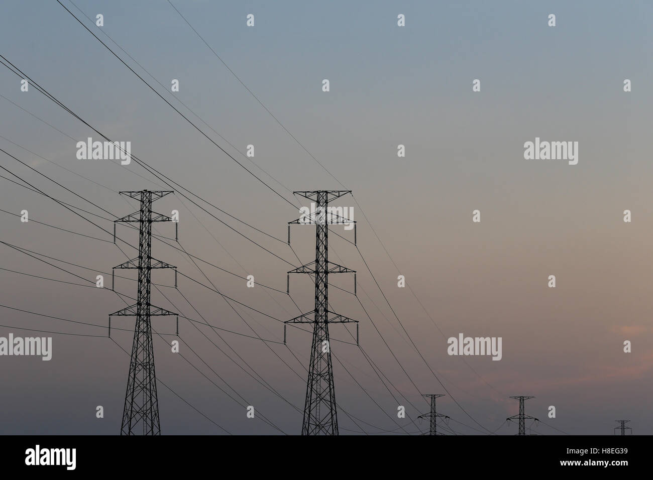 high voltage pole of transmission lines at twilight sunset Stock Photo ...