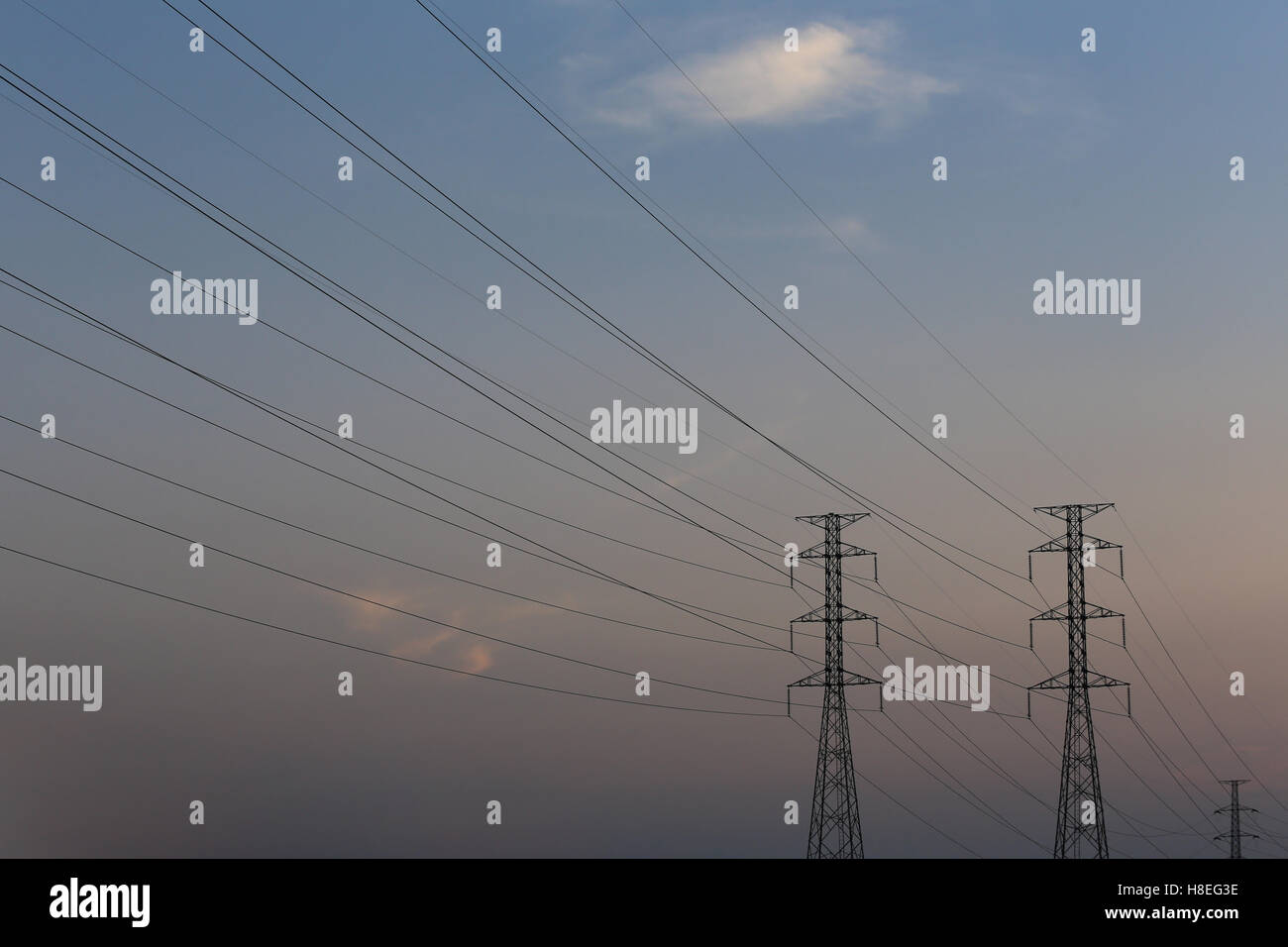 high voltage pole of transmission lines at twilight sunset Stock Photo