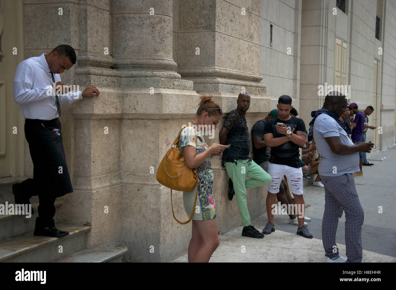 People with smartphones in the streets of La Havana - Cuba Stock Photo